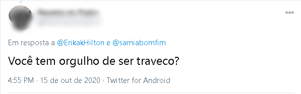 Tweet direcionado à Erika Hilton que diz "Você tem orgulho de ser traveco?"